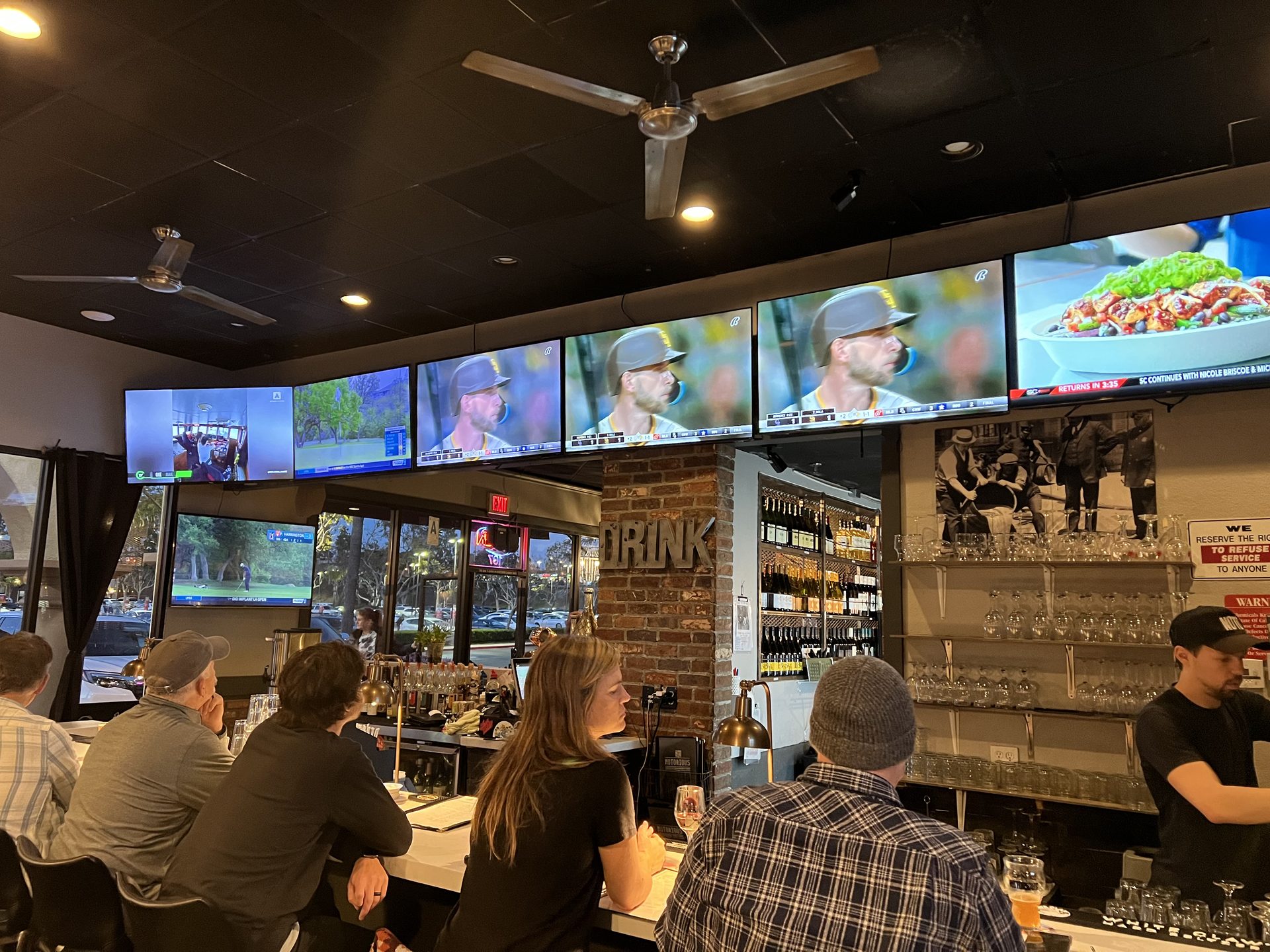 TVs above the bar and patrons watching the game at Notorious Sports Bar & Grill in Carlsbad