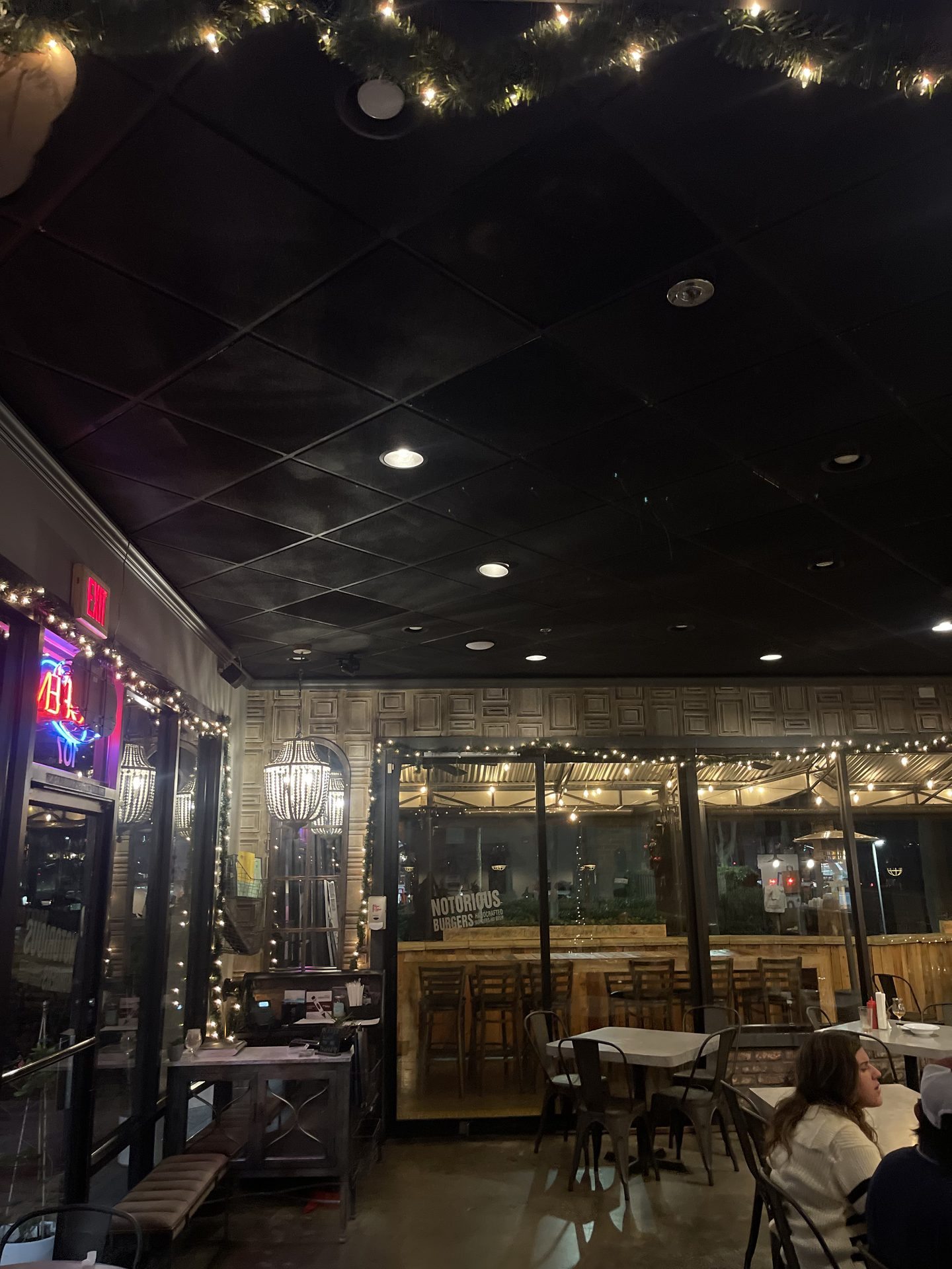 Dining room interior at Notorious Sports Bar & Grill in Carlsbad — string lights, chandeliers, mood lighting